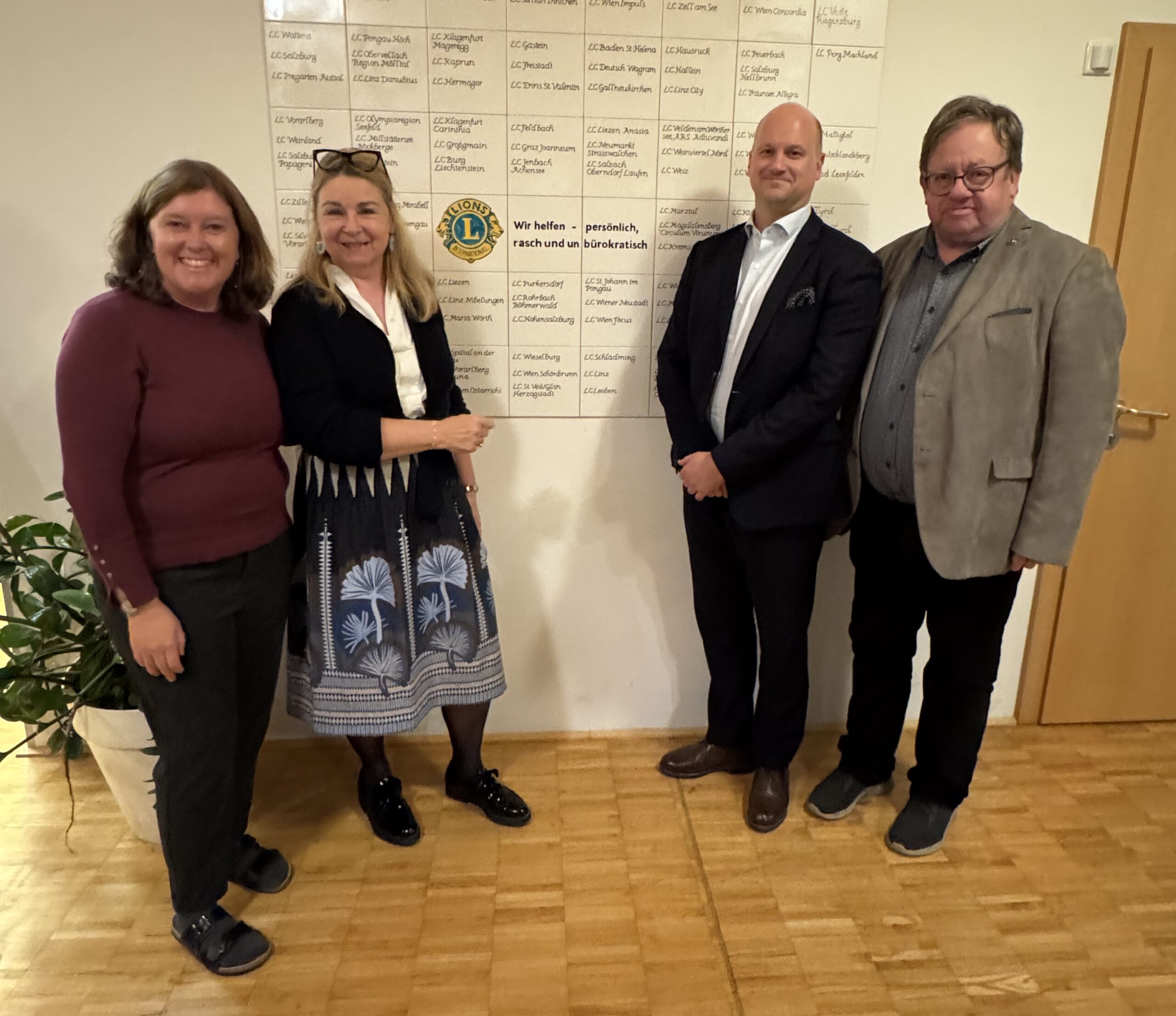 Vor der Wand der spendenden Lions Clubs (v.l.n.r.) die neue Geschäftsführerin Martina Weber, Frau Distriktgovernor Daniela Werndl, LC Präsident Stefan Millinger und Clubsekretär Hannes Rosner. Bild: LC Seekirchen/Millinger-Neumayr